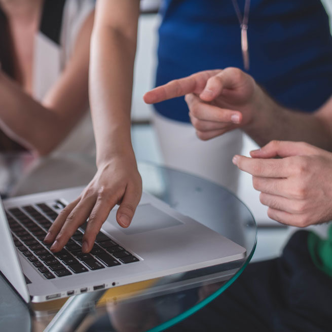 Person teaching other at computer